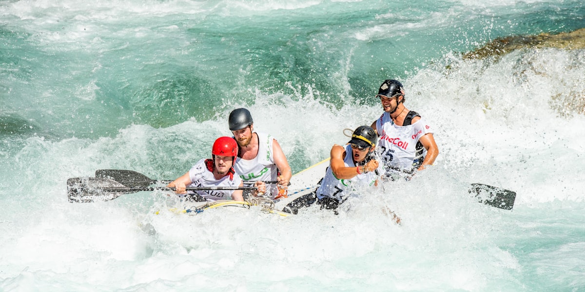 Crew paddling hard through white water