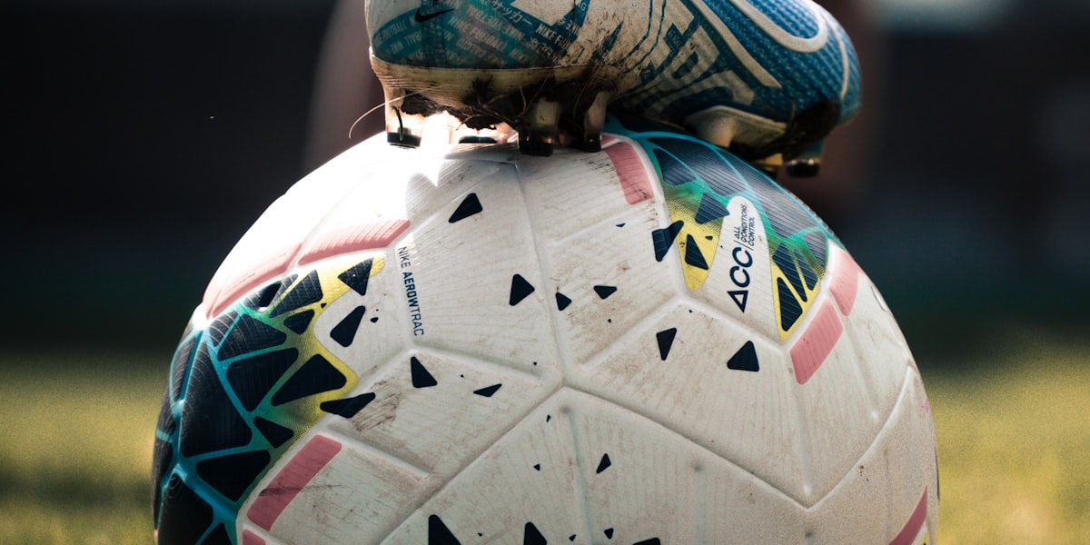Football boot resting on a match ball